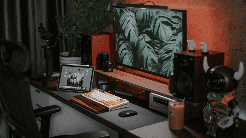 A compact 40-inch desk setup illustrating how an under-monitor riser with built-in storage drawers reclaims surface area for a mechanical keyboard and mouse.