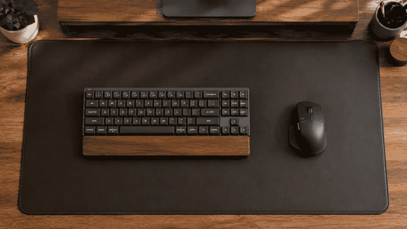 A desk mat providing a unified surface for keyboard and mouse showing the visual organization and clean workspace benefit