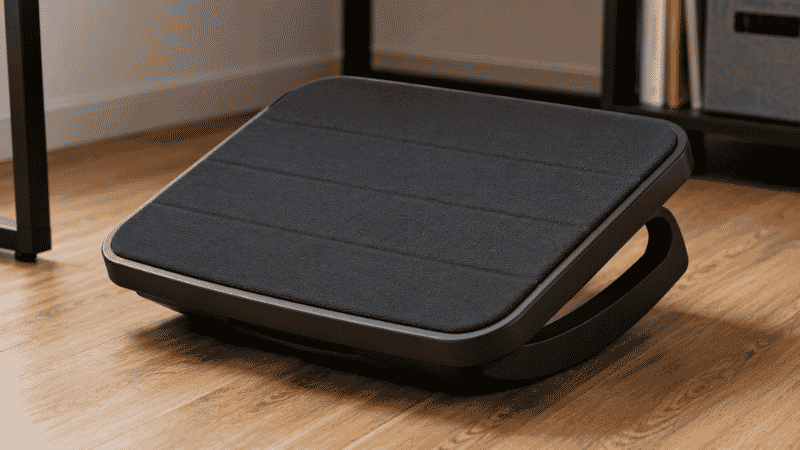 A rocking footrest with a curved base showing its rocking motion design that encourages foot movement and improves circulation