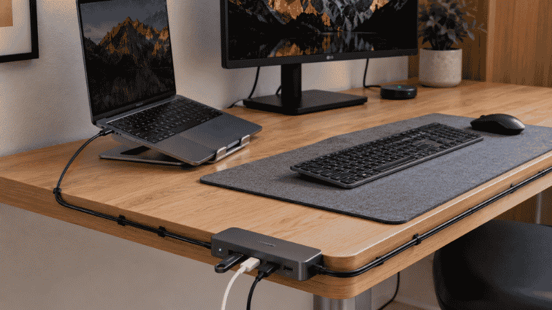 A simple USB splitter adapter plugged into a laptop expanding one USB port into three ports with a mouse and flash drive connected